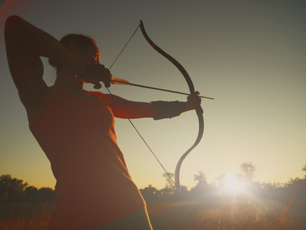 someone with an archery bow and arrow