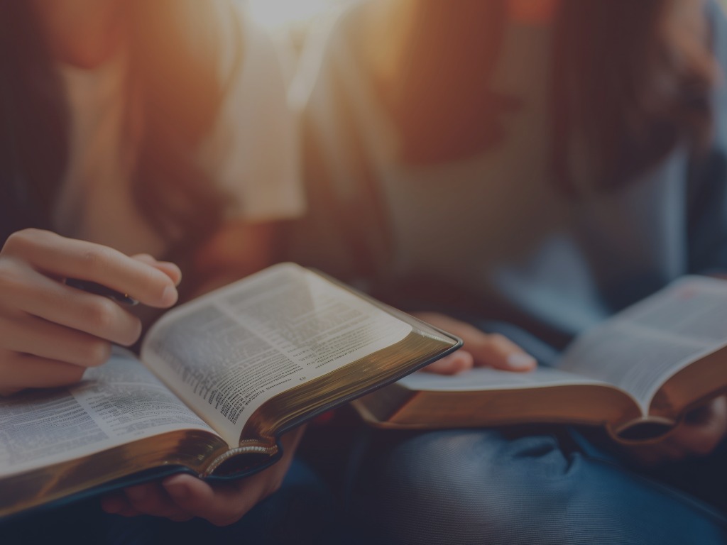 people looking at Bibles